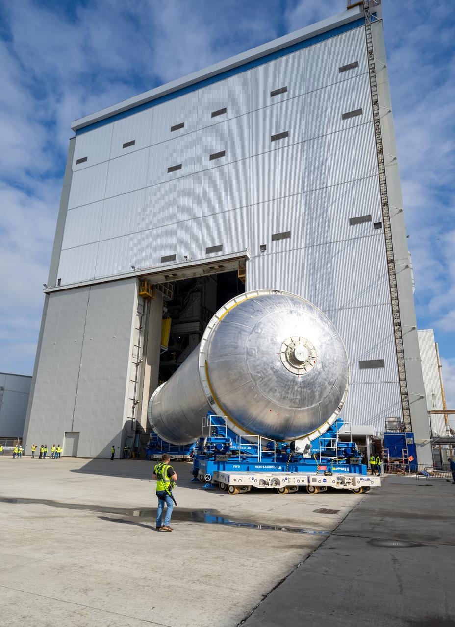 Teams move the core stage liquid hydrogen tank for the Artemis III mission to a priming cell near the Vertical Assembly Building at NASA’s Michoud Assembly Facility in New Orleans Nov. 21. Technichians will sand down and prepare the suface of the tank before coating it in a primer. Primer is applied to the barrel section of the tank by an automated robotic tool, whereas the forward and aft domes are primed manually.   Once priming is complete, technicians with NASA and Boeing, the SLS core stage prime contractor, will apply a foam-based thermal protection system, which protects the propellant tank from the extreme temperatures it will face during launch and flight while also regulating the super-chilled propellant within it. The propellant tank is one of five major elements that make up the 212-foot-tall rocket stage. The core stage, along with its four RS-25 engines, produce two million pounds of thrust to help launch NASA’s Orion spacecraft, astronauts, and supplies beyond Earth’s orbit and to the lunar surface for Artemis.   
